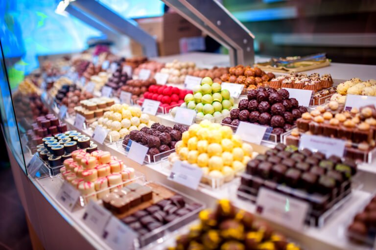 chocolate truffes, candies and sweets store on showcase in factory