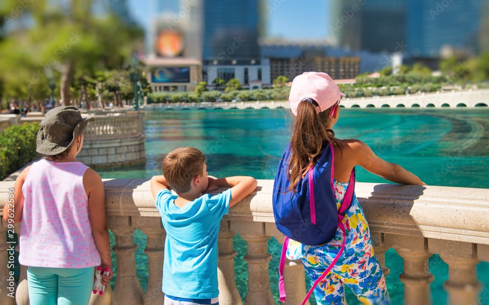 Three young children amazed by Las Vegas Trip attractions, back view - 10 Kid-Friendly Activities on the Las Vegas Strip in 2024